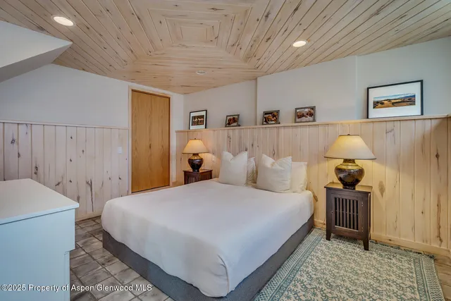 a bedroom with a bed and a table