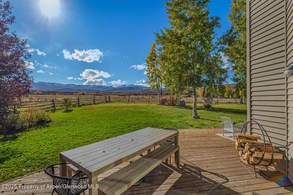 a view of a wooden deck and a yard