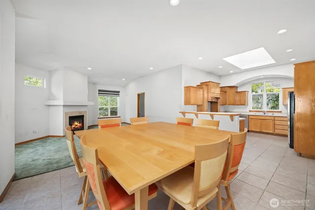 a kitchen with stainless steel appliances kitchen island granite countertop a refrigerator and a stove top oven