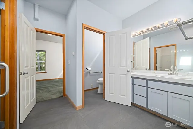 a spacious bathroom with a double vanity sink mirror and shower