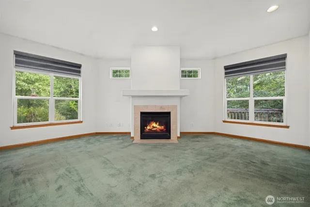 a view of an empty room with a fireplace