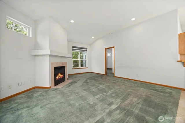 a view of a livingroom with a fireplace and a window