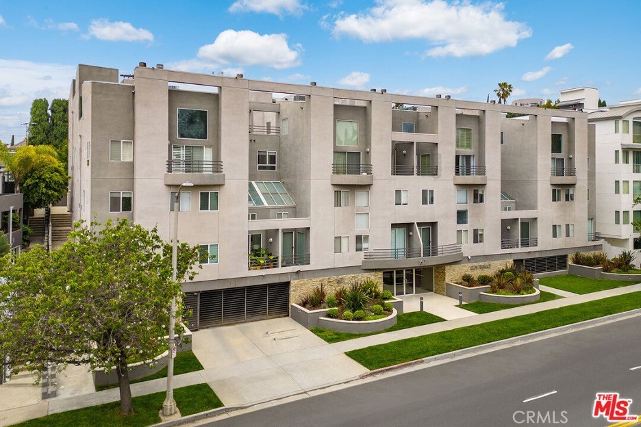 1617 South Beverly Glen Boulevard, Unit 303 Los Angeles, CA 90024 - Photo 1 of 55 a front view of a building with a garden and plants