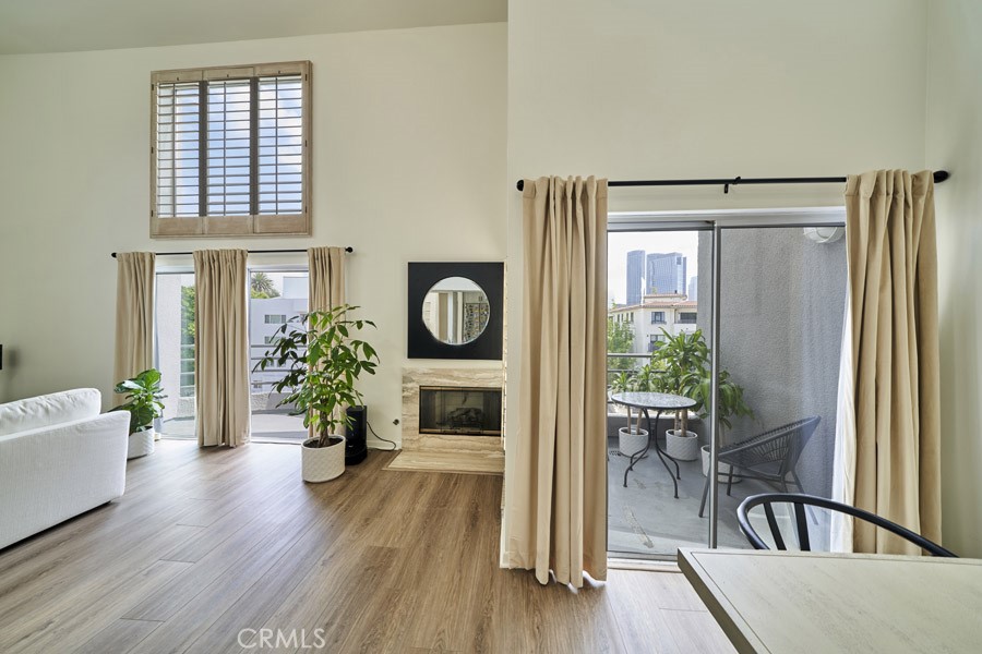 1617 South Beverly Glen Boulevard, Unit 303 Los Angeles, CA 90024 - Photo 12 of 55 a living room with furniture and a fireplace