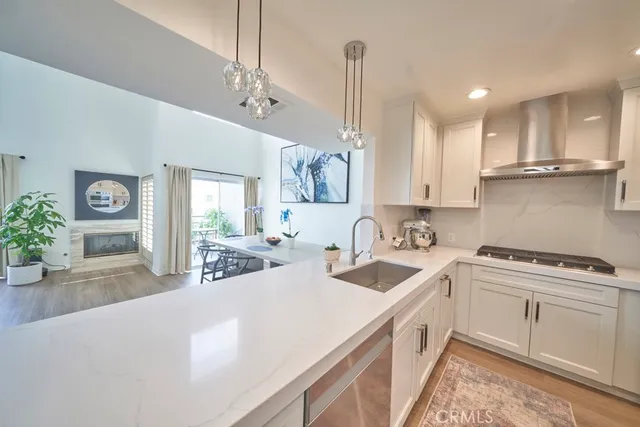 a kitchen with a sink stove and white cabinets