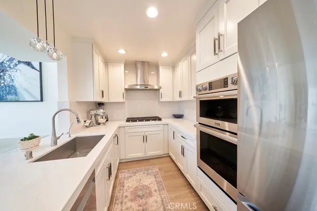 a kitchen with a sink a stove and oven
