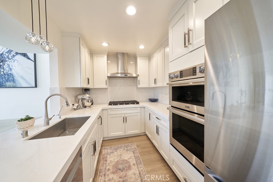 1617 South Beverly Glen Boulevard, Unit 303 Los Angeles, CA 90024 - Photo 14 of 55 a kitchen with a sink a stove and oven