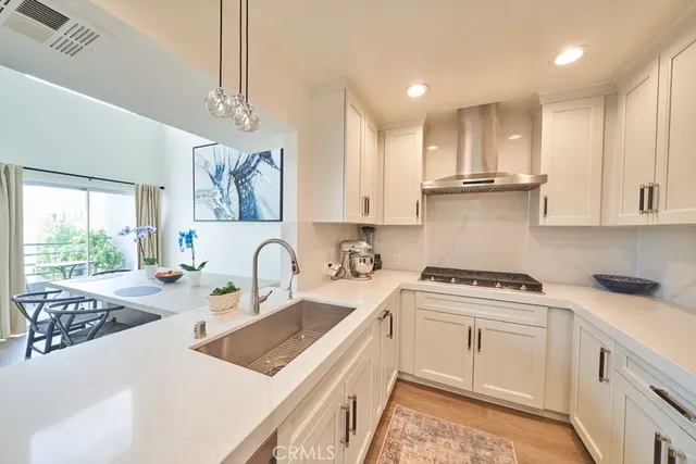 a kitchen with stainless steel appliances granite countertop a sink stove and cabinets