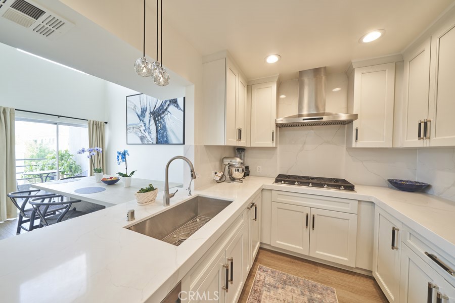 1617 South Beverly Glen Boulevard, Unit 303 Los Angeles, CA 90024 - Photo 17 of 55 a kitchen with stainless steel appliances granite countertop a sink stove and cabinets