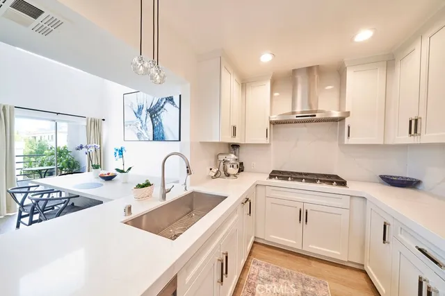 a kitchen with stainless steel appliances granite countertop a sink stove and cabinets
