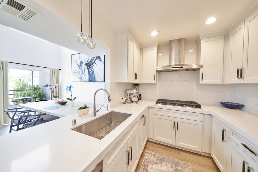1617 South Beverly Glen Boulevard, Unit 303 Los Angeles, CA 90024 - Photo 18 of 55 a kitchen with stainless steel appliances granite countertop a sink stove and cabinets