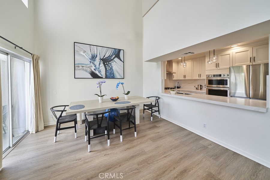 1617 South Beverly Glen Boulevard, Unit 303 Los Angeles, CA 90024 - Photo 19 of 55 a living room with stainless steel appliances kitchen island granite countertop furniture and wooden floor