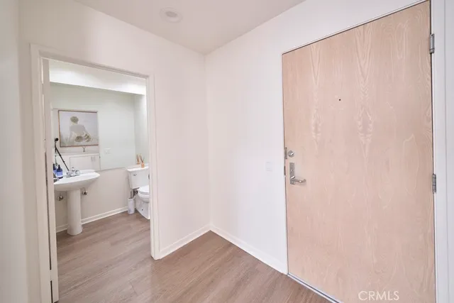 a view of bathroom with a toilet a sink and a mirror