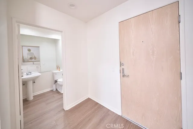 a room with a wooden floor and a bathroom view