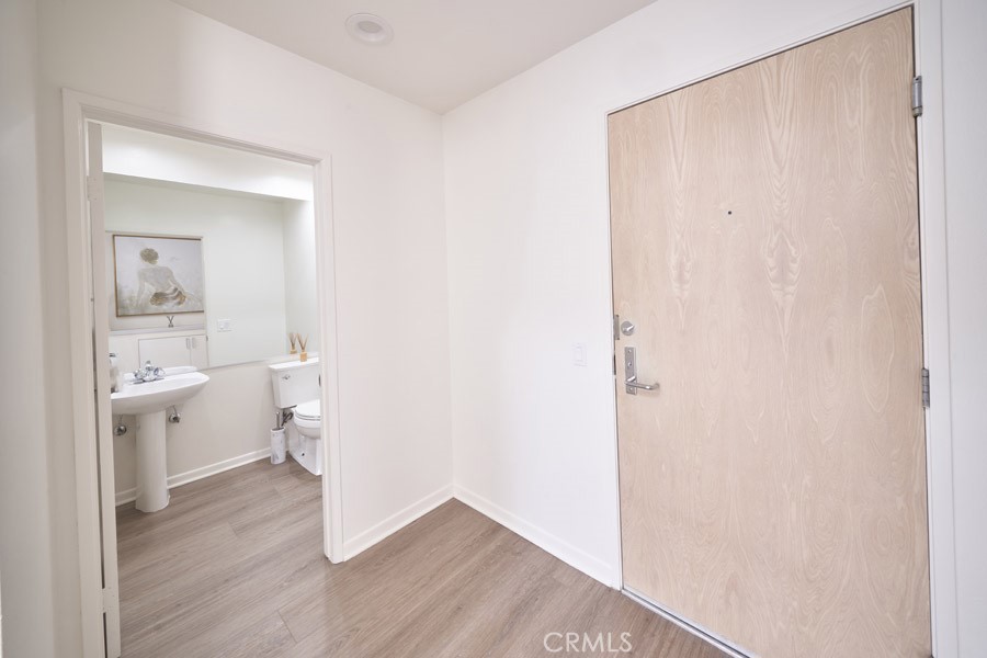 1617 South Beverly Glen Boulevard, Unit 303 Los Angeles, CA 90024 - Photo 24 of 55 a room with a wooden floor and a bathroom view