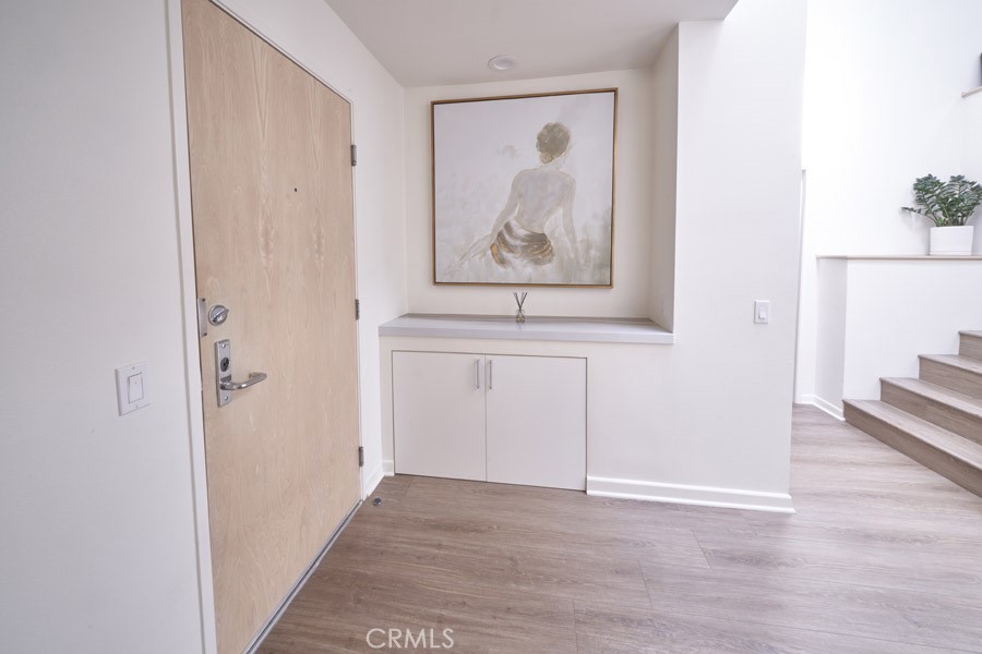 1617 South Beverly Glen Boulevard, Unit 303 Los Angeles, CA 90024 - Photo 25 of 55 a view of a hallway with wooden floor and a bathroom