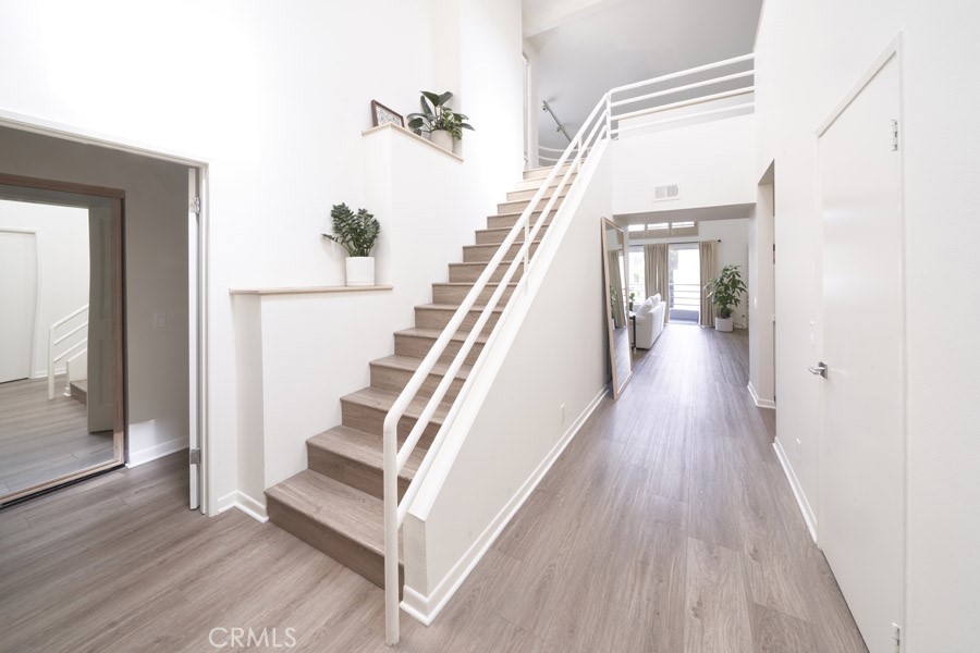 1617 South Beverly Glen Boulevard, Unit 303 Los Angeles, CA 90024 - Photo 26 of 55 a view of a hallway with wooden floor and staircase