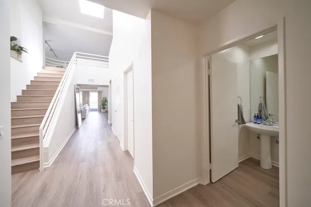 a view of a hallway with wooden floor and entryway