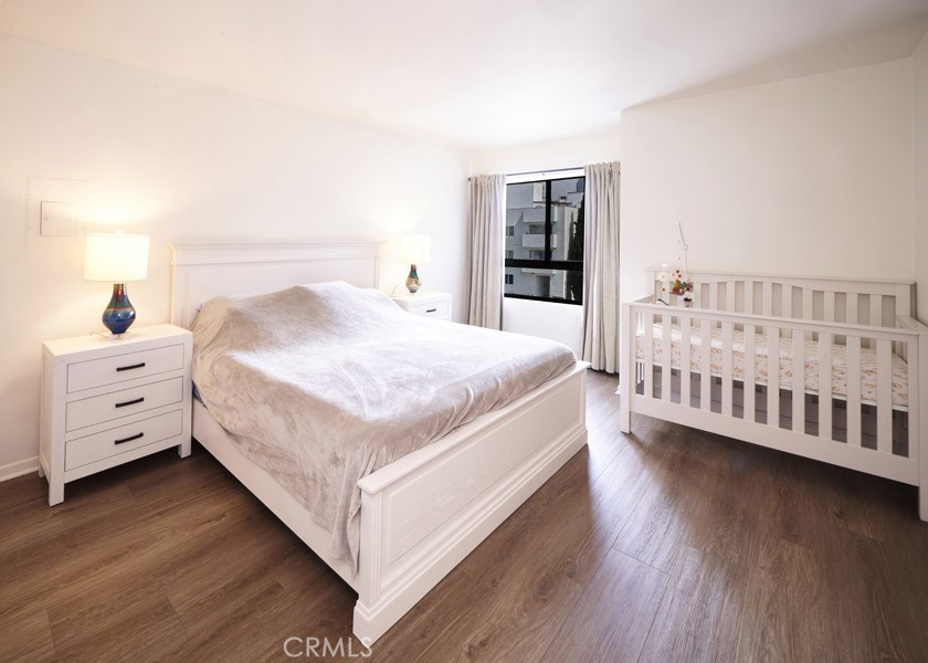 1617 South Beverly Glen Boulevard, Unit 303 Los Angeles, CA 90024 - Photo 31 of 55 a bedroom with a bed and a window