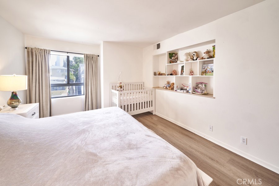 1617 South Beverly Glen Boulevard, Unit 303 Los Angeles, CA 90024 - Photo 32 of 55 a bedroom with a bed and a window