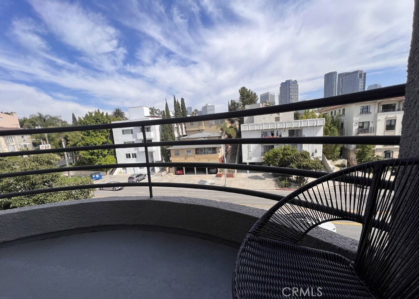 1617 South Beverly Glen Boulevard, Unit 303 Los Angeles, CA 90024 - Photo 48 of 55 a balcony with furniture and city view