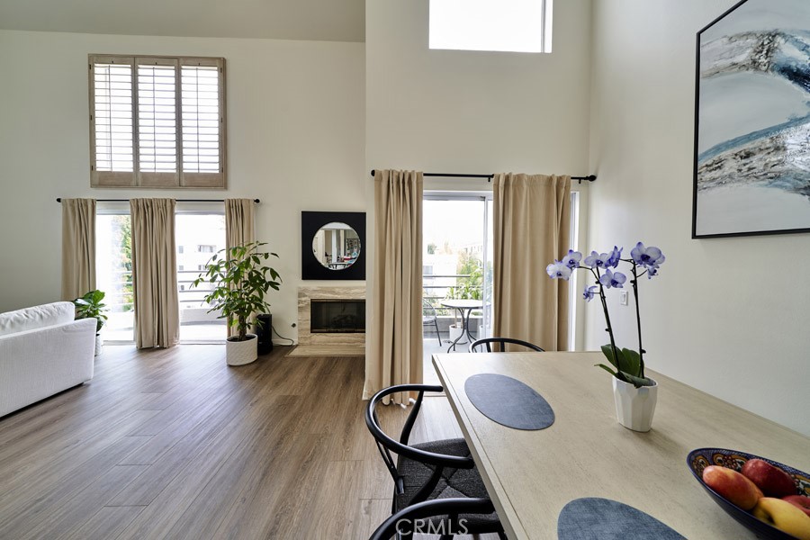 1617 South Beverly Glen Boulevard, Unit 303 Los Angeles, CA 90024 - Photo 10 of 55 a dining room with furniture potted plants and wooden floor