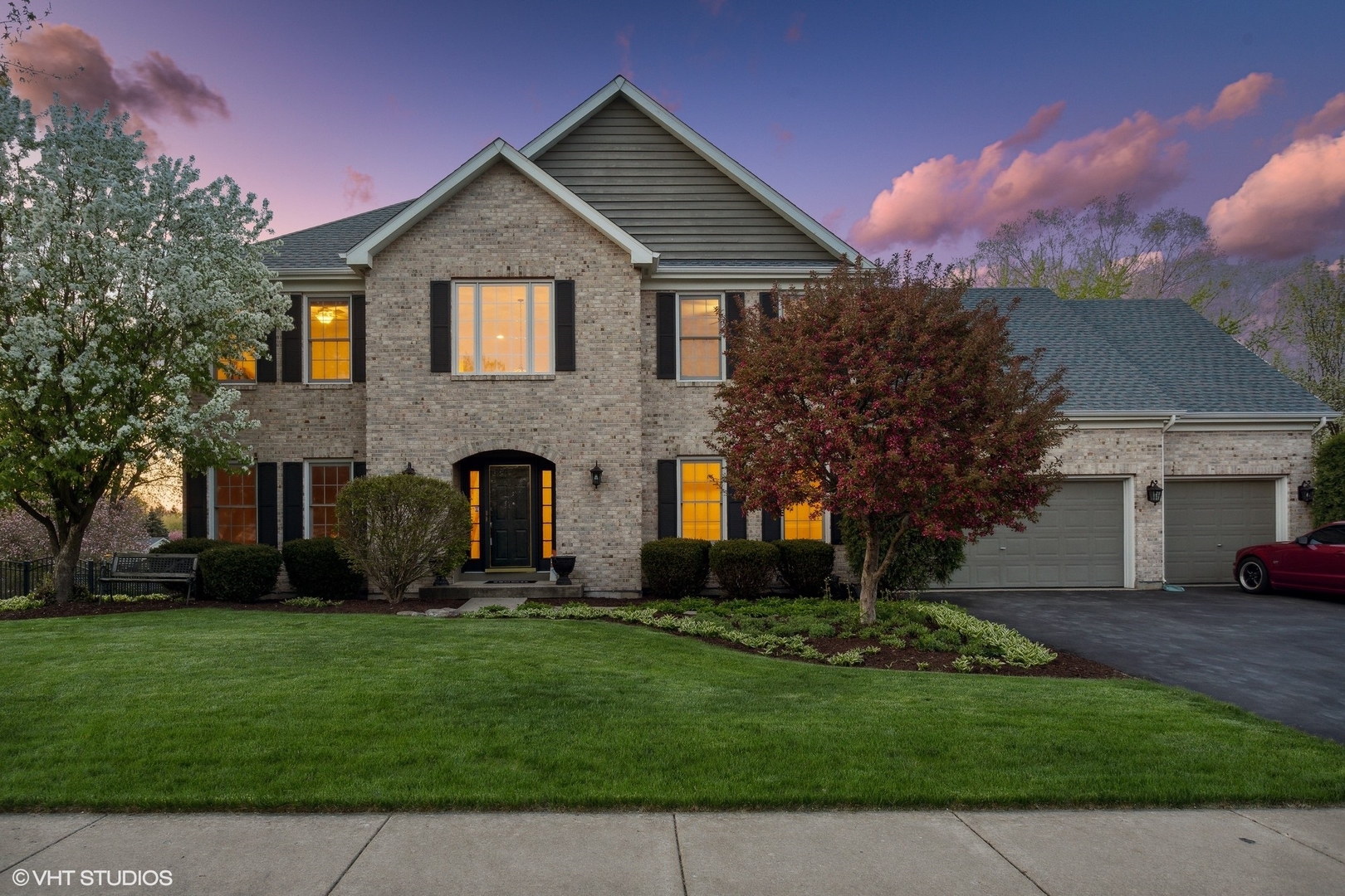 a front view of a house with a garden and yard