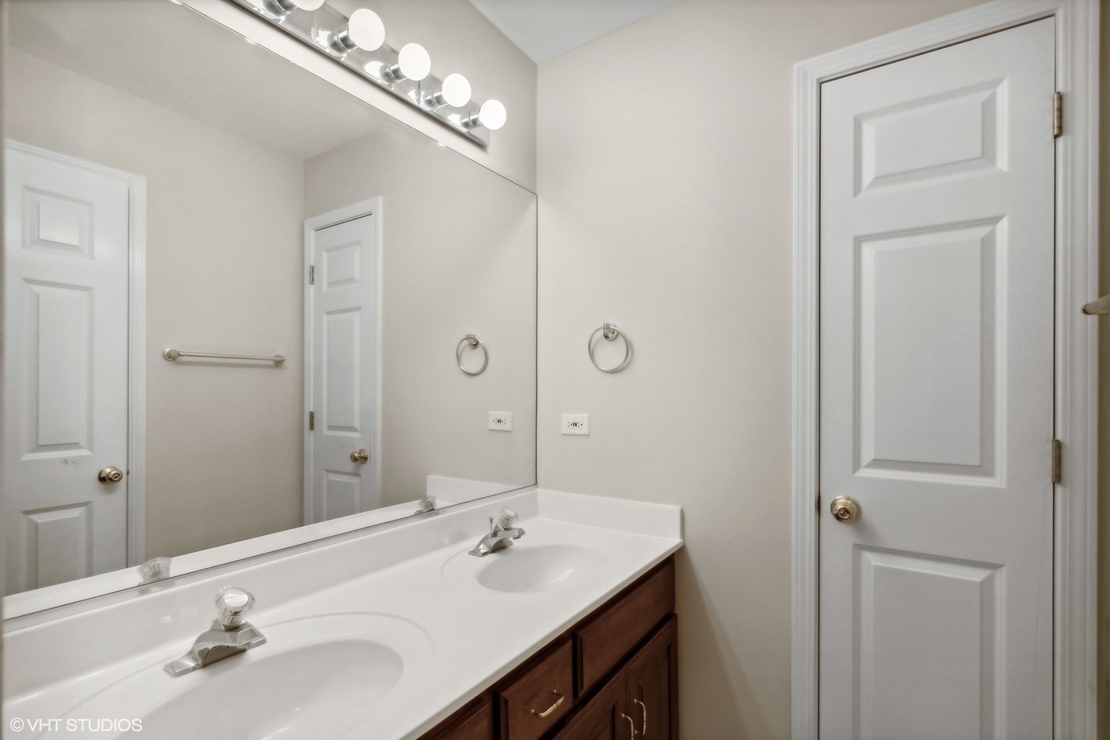 2223 Joyce Lane Naperville, IL 60564 - Photo 22 of 36 a bathroom with double vanity and a mirror