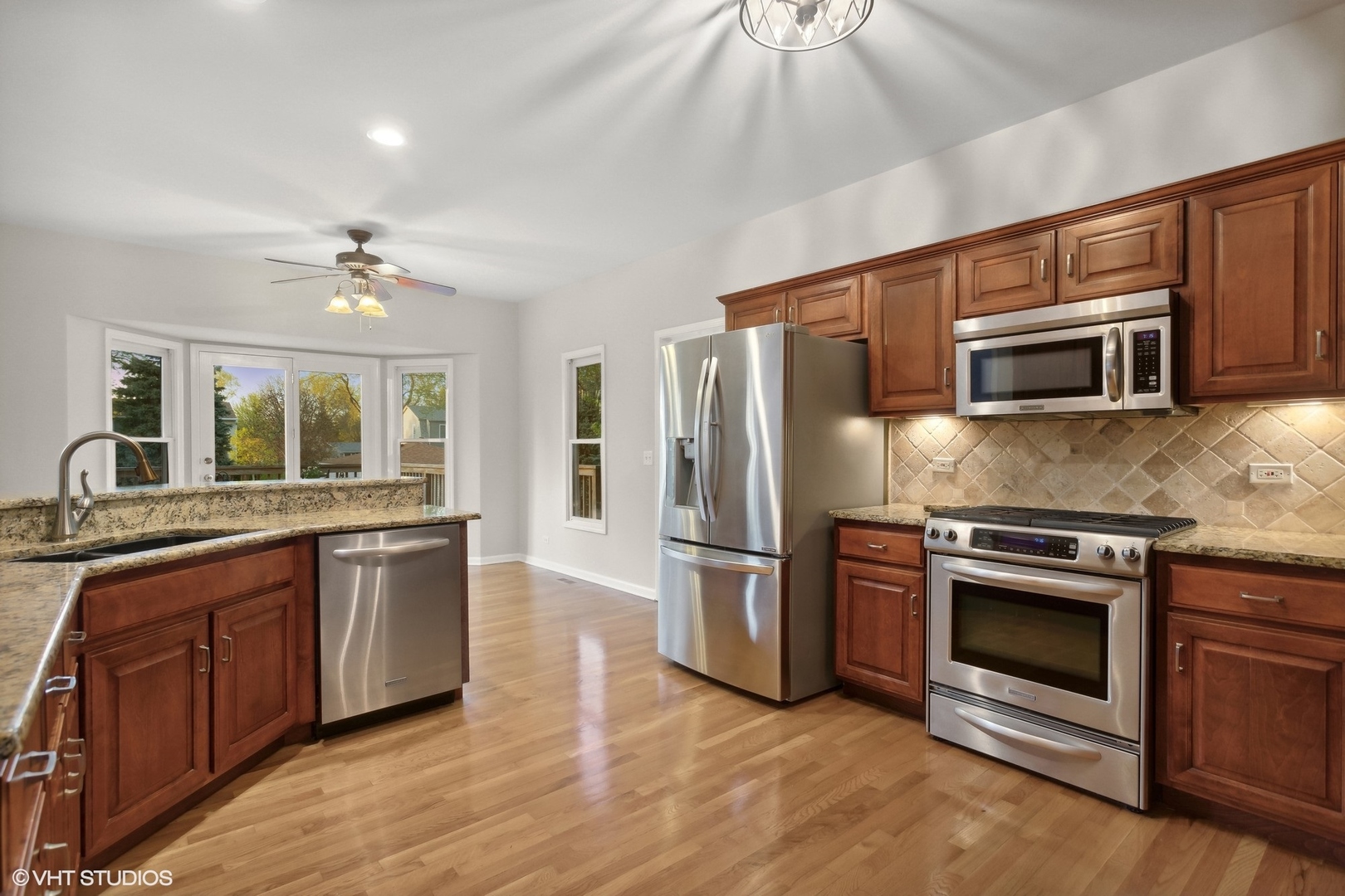 2223 Joyce Lane Naperville, IL 60564 - Photo 5 of 36 a kitchen with stainless steel appliances granite countertop a stove microwave and refrigerator