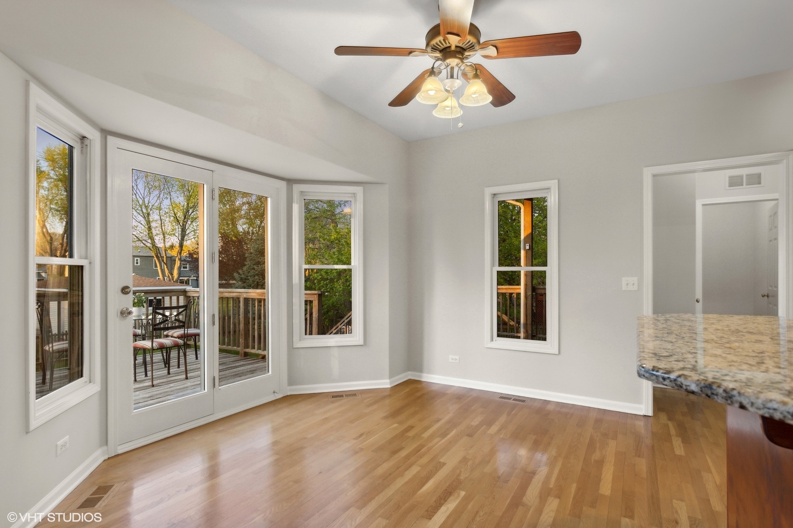 2223 Joyce Lane Naperville, IL 60564 - Photo 6 of 36 a view of an empty room with a window and wooden floor