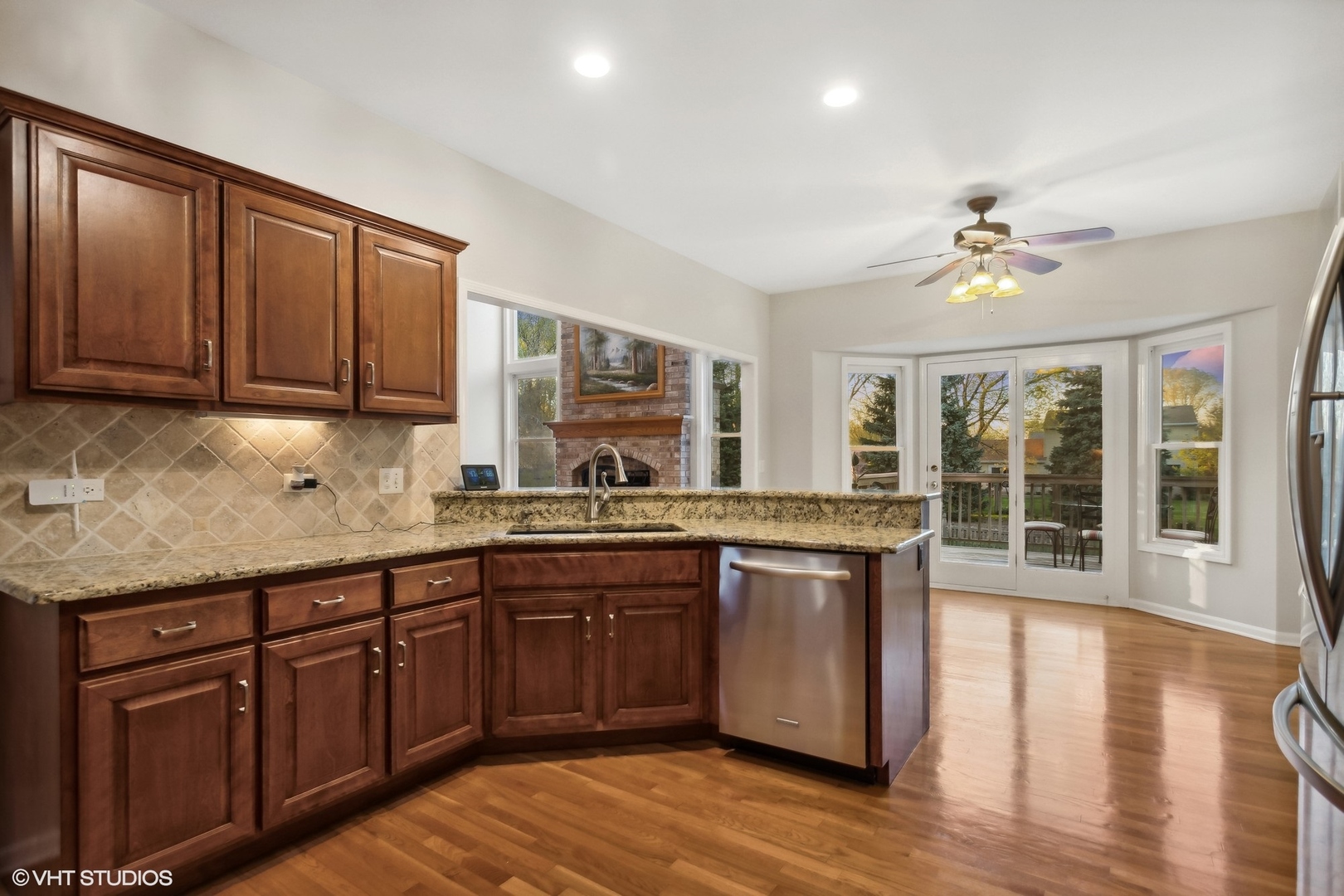 2223 Joyce Lane Naperville, IL 60564 - Photo 8 of 36 a kitchen with stainless steel appliances granite countertop wooden cabinets a stove a sink and dishwasher with wooden floor