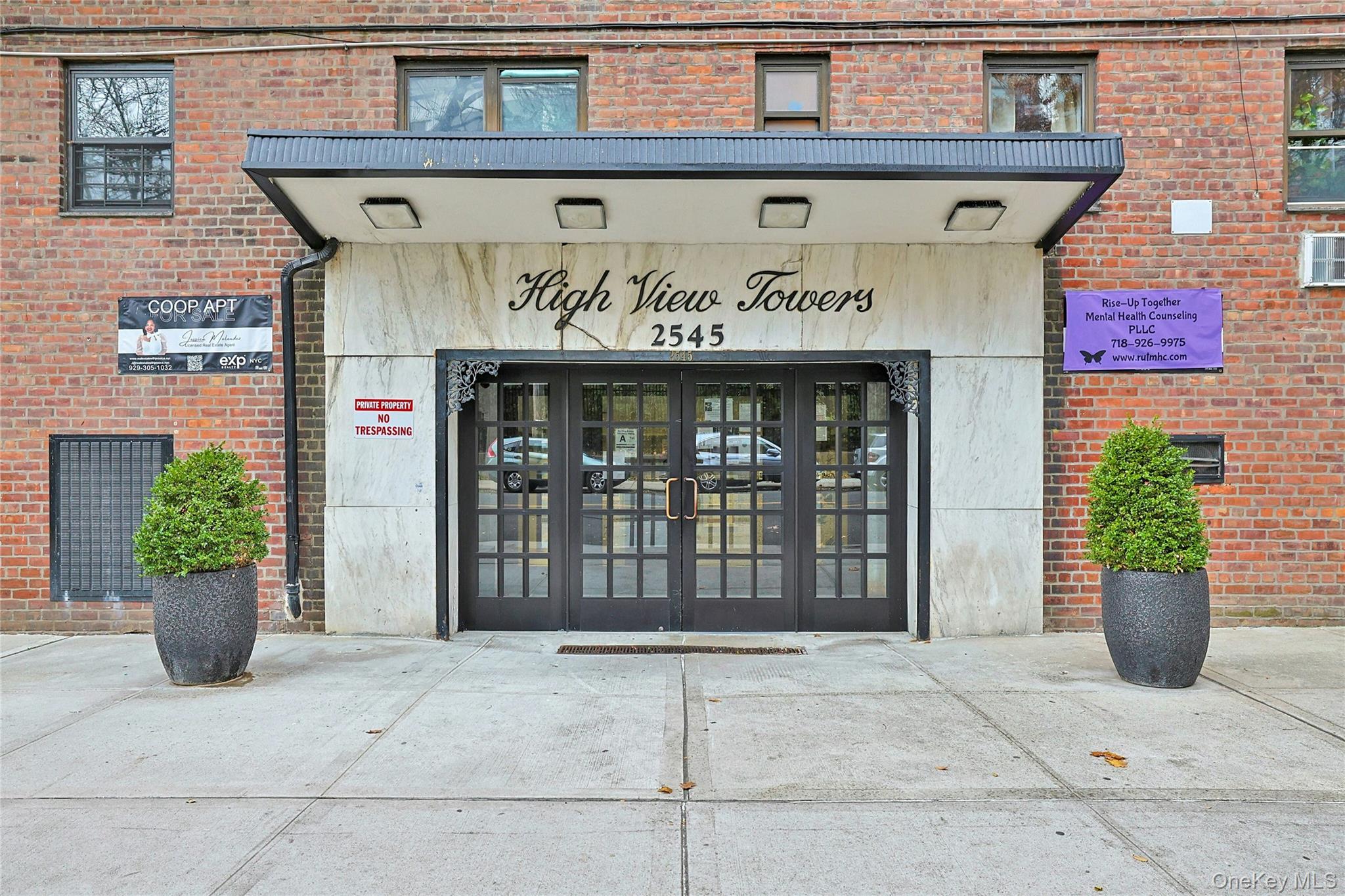 Entrance to property featuring french doors and brick siding