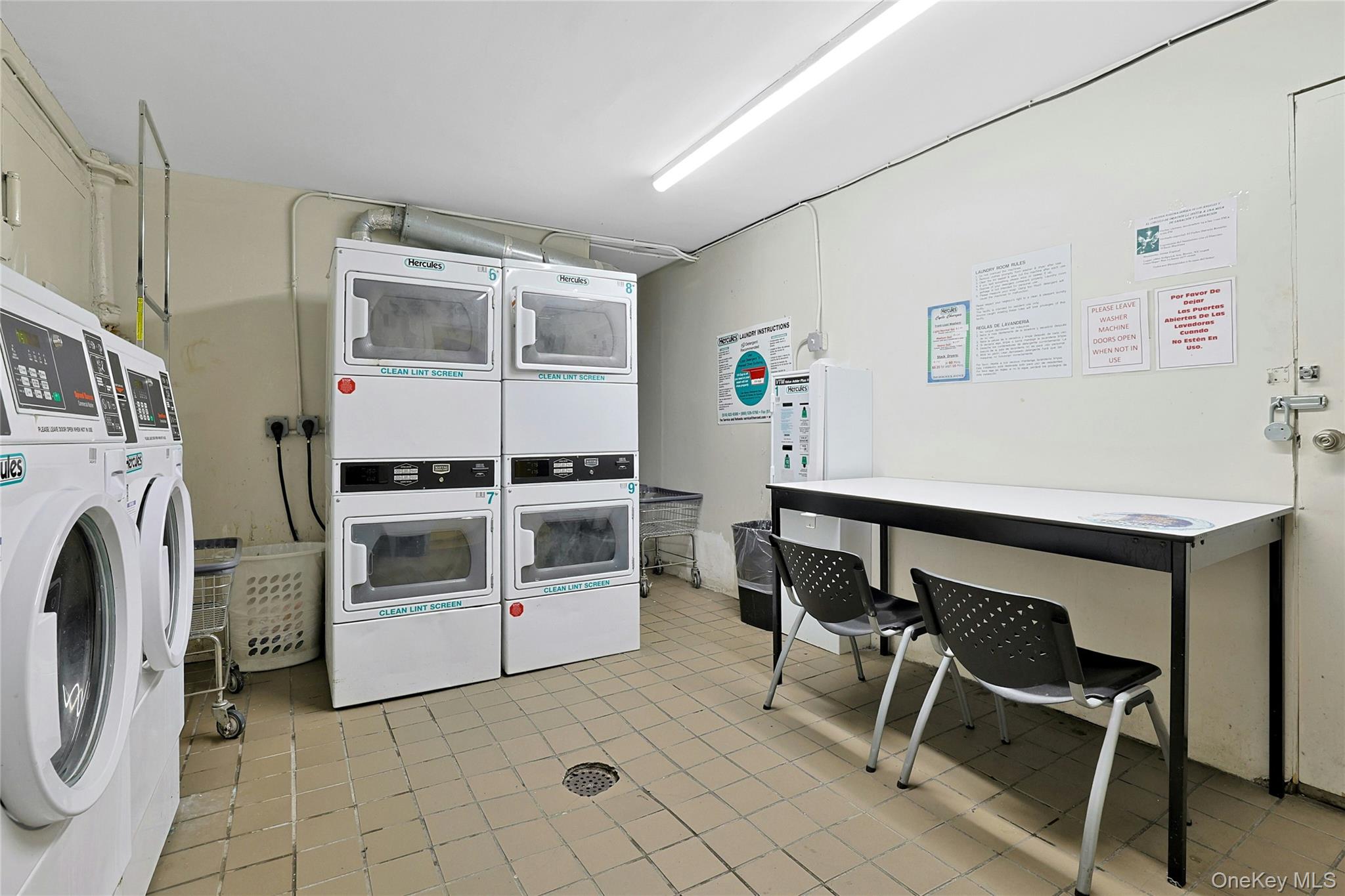 2545 Sedgwick Avenue, Unit 3 Bronx, NY 10468 - Photo 11 of 15 Community laundry room with washing machine and dryer & clothes folding table