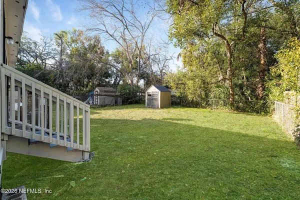 a view of a garden with wooden fence
