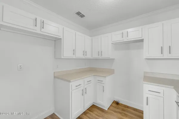 a view of cabinets with wooden floor