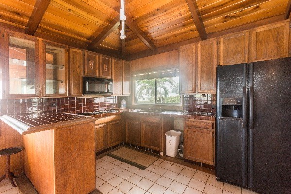 1054 Kealoha Road Kapaa, HI 96746 - Photo 13 of 18 a kitchen with stainless steel appliances granite countertop a sink stove and refrigerator