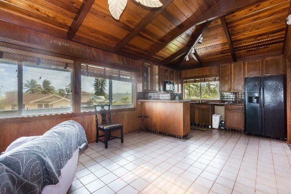 1054 Kealoha Road Kapaa, HI 96746 - Photo 17 of 18 a kitchen with granite countertop a refrigerator and wooden cabinets