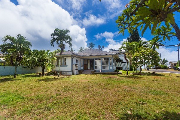 1054 Kealoha Road Kapaa, HI 96746 - Photo 2 of 18 a front view of a house with a yard