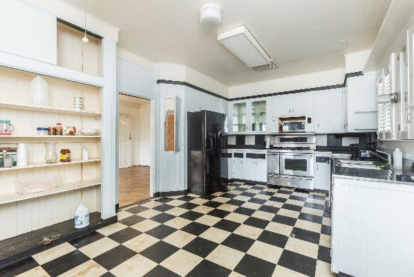 1054 Kealoha Road Kapaa, HI 96746 - Photo 3 of 18 a kitchen with stainless steel appliances a refrigerator and cabinets