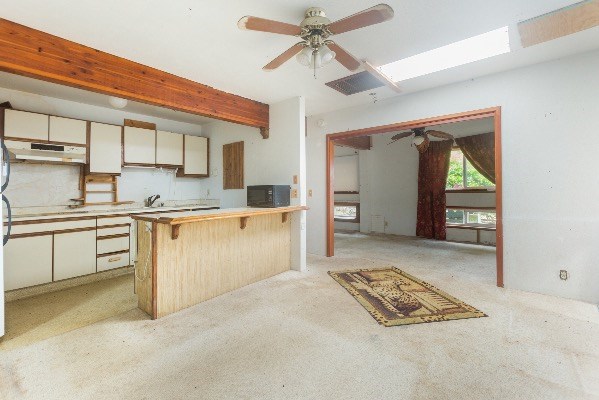 1054 Kealoha Road Kapaa, HI 96746 - Photo 9 of 18 a kitchen with stainless steel appliances granite countertop a stove a sink and a refrigerator