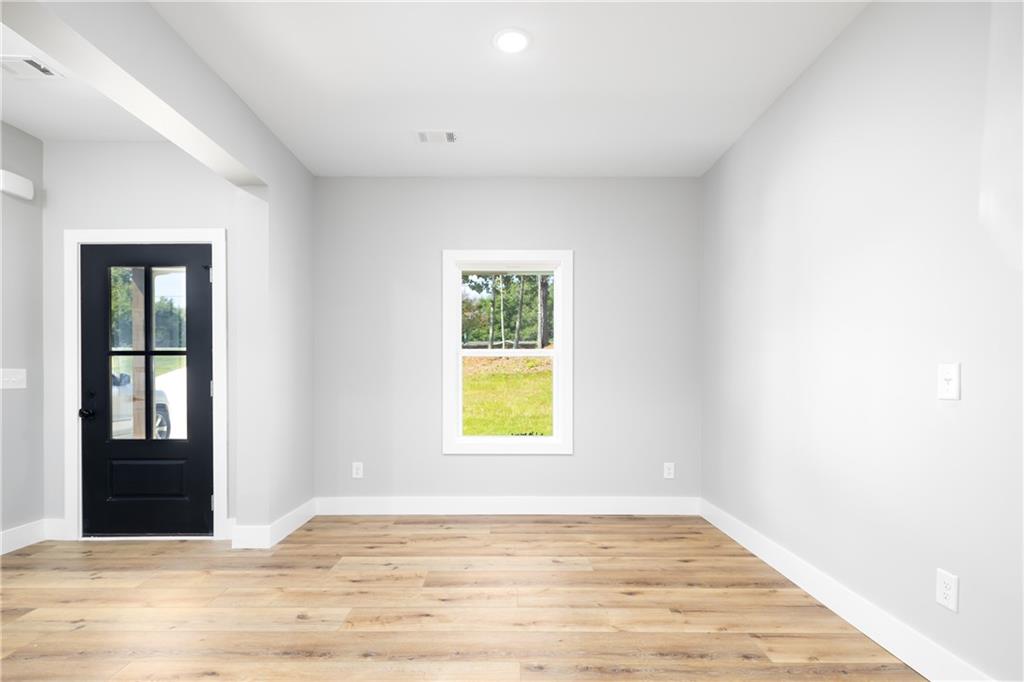 111 Lee Road Phenix City, AL 36867 - Photo 7 of 23 Light wood-finish flooring with white trim