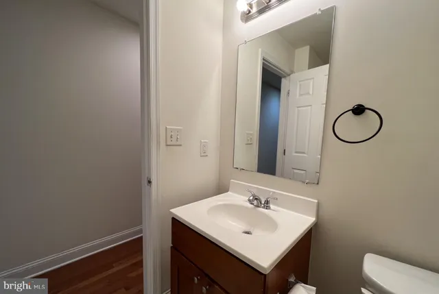 a bathroom with a sink a toilet and mirror