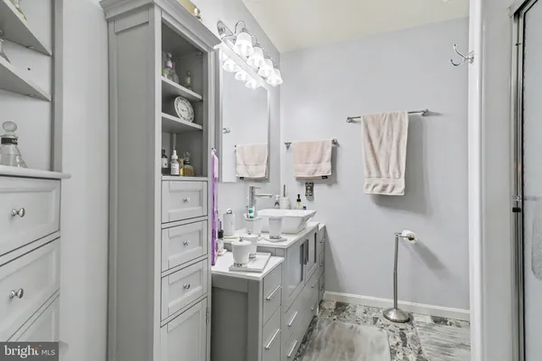 a bathroom with a sink vanity mirror and toilet