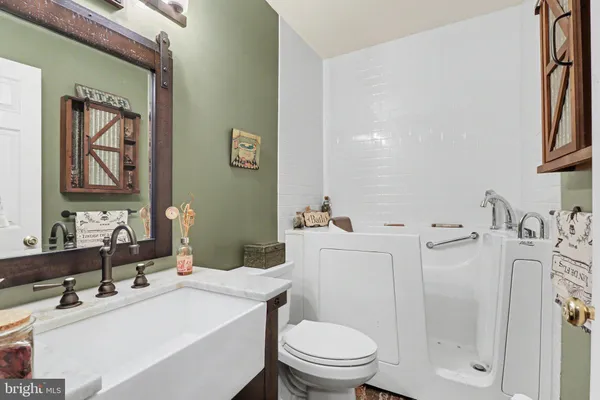 a view of walk in closet with clothes