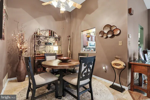 a view of a dining room with furniture and chandelier