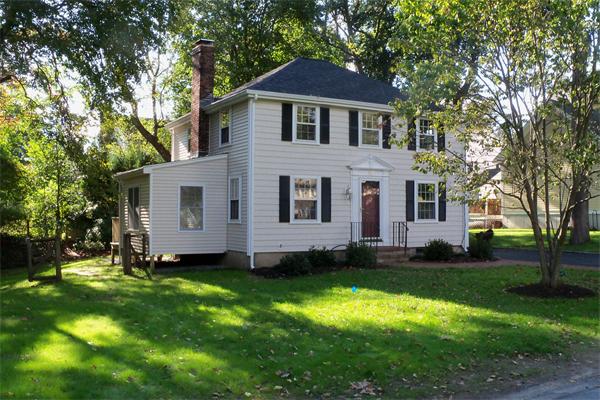52 Martin Road Wellesley, MA 02481 - Photo 1 of 10 a view of a white house with a big yard and large trees