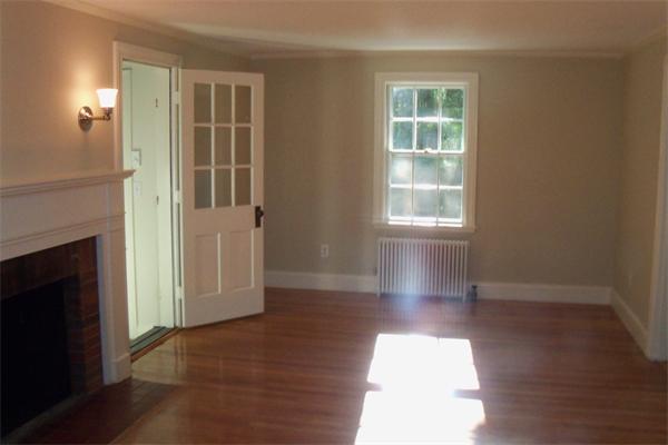 52 Martin Road Wellesley, MA 02481 - Photo 6 of 10 a view of empty room with wooden floor and fireplace