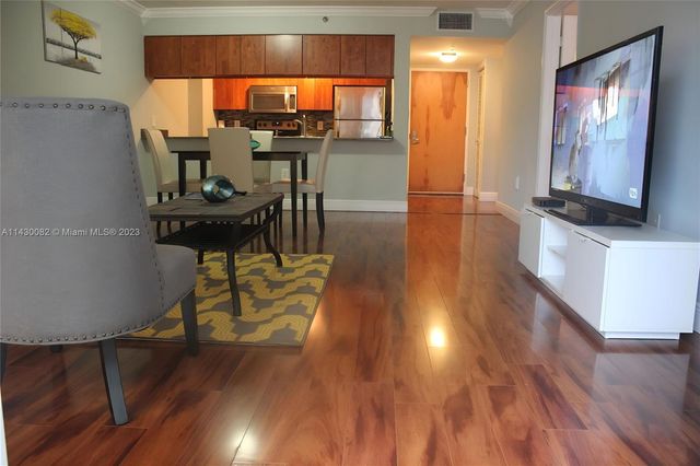 a view of a living room with furniture and wooden floor