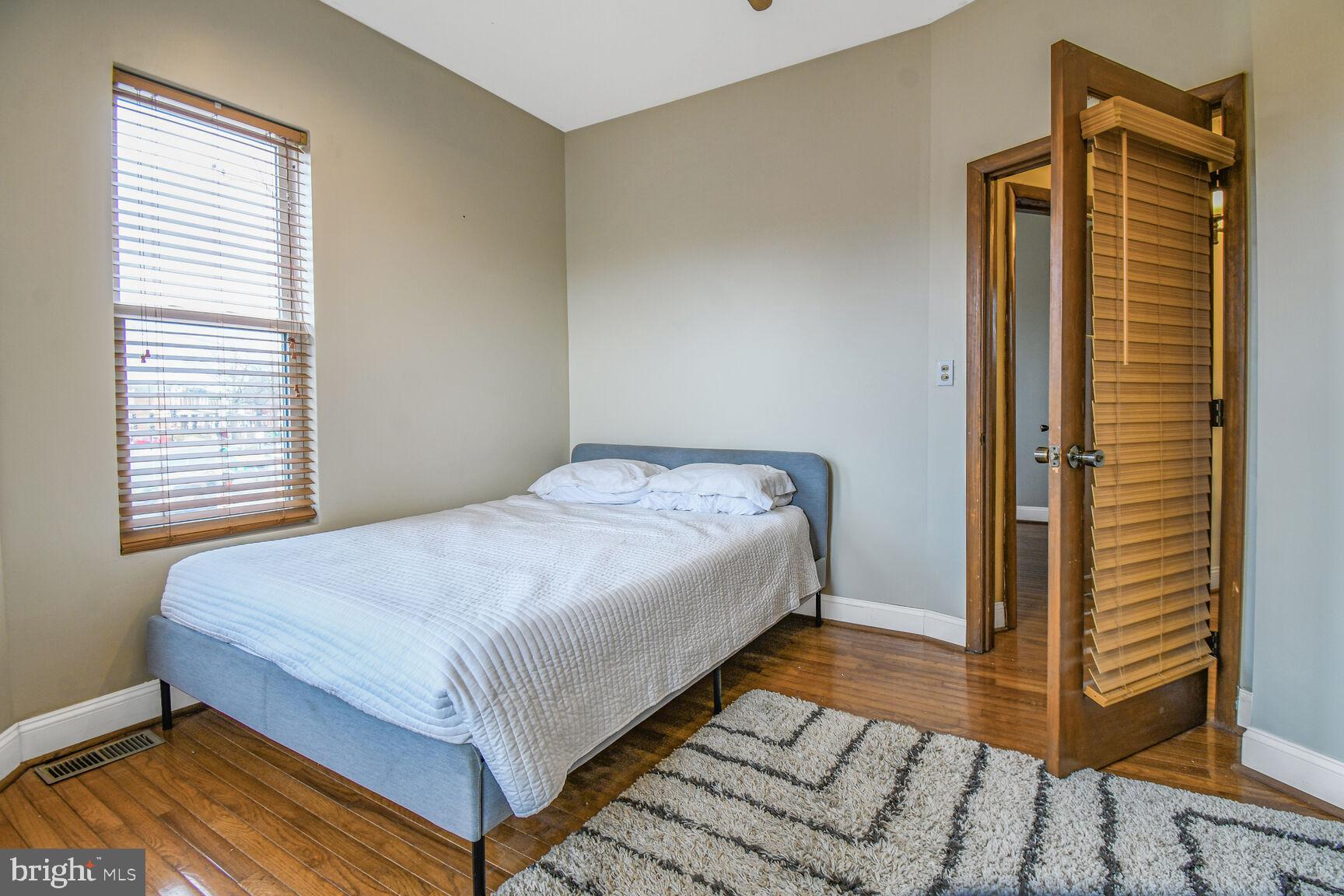 414 Florida Avenue Northwest Washington, DC 20001 - Photo 12 of 24 a bedroom with a bed and a window