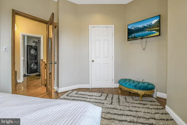 a bedroom with a bed and a potted plant